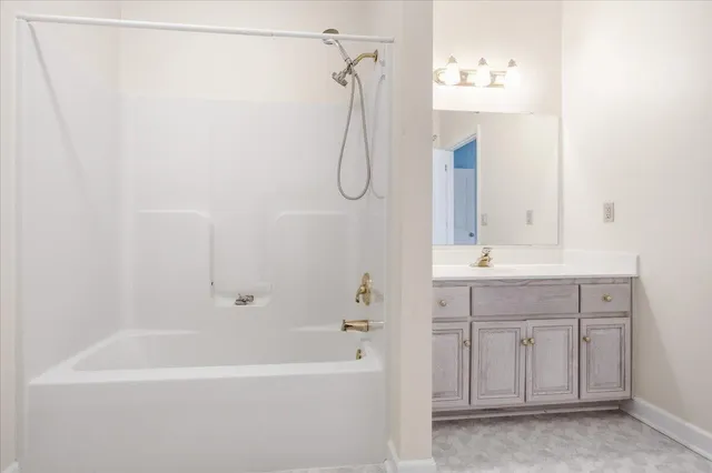 a living room with furniture and flowers