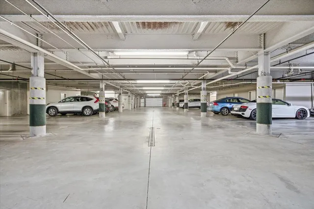 a view of parking garage with cars