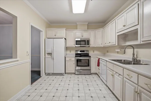 a kitchen with stainless steel appliances granite countertop a sink and cabinets