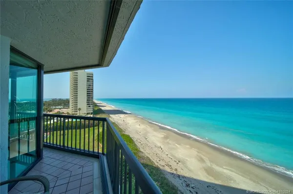 a view of a balcony with yard