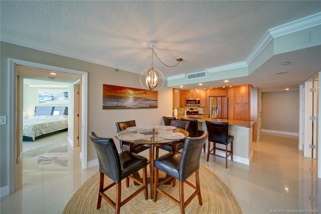 8800 South Ocean Drive, Unit 905 Jensen Beach, FL 34957 - Photo 14 of 67 a view of a dining room with furniture window and outside view