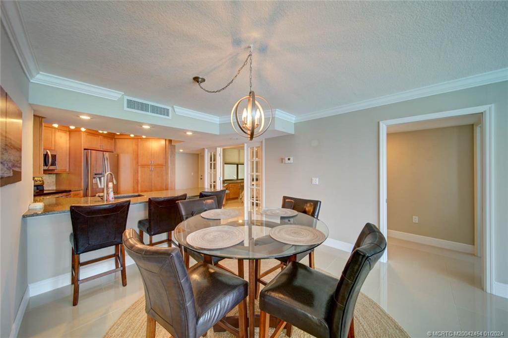 8800 South Ocean Drive, Unit 905 Jensen Beach, FL 34957 - Photo 15 of 67 a view of a dining room with furniture window and outside view