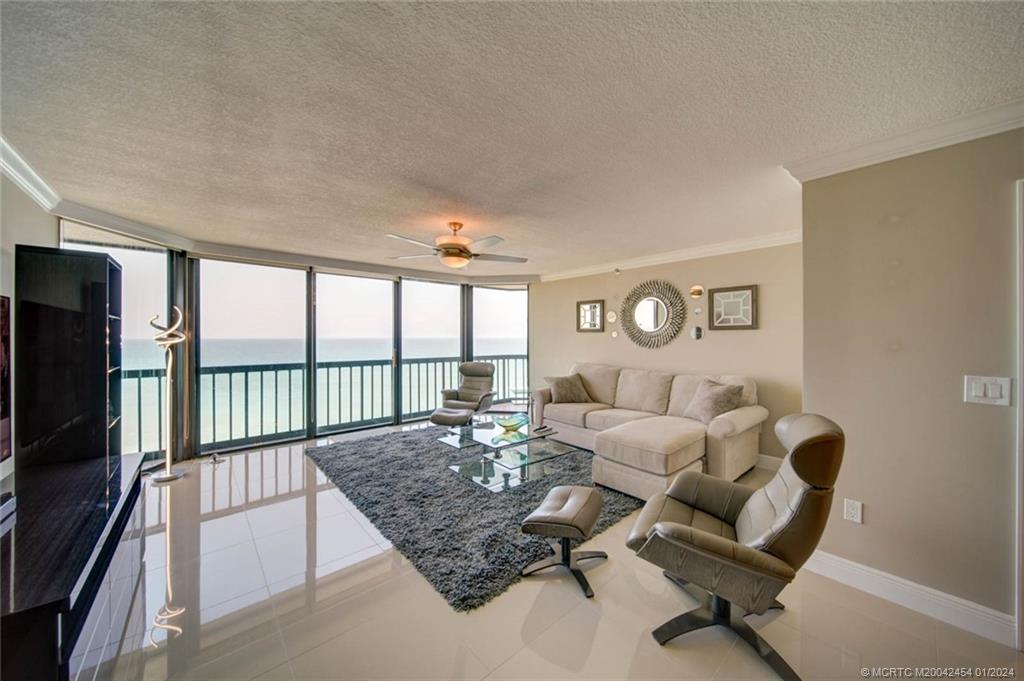 8800 South Ocean Drive, Unit 905 Jensen Beach, FL 34957 - Photo 16 of 67 a living room with furniture and a floor to ceiling window