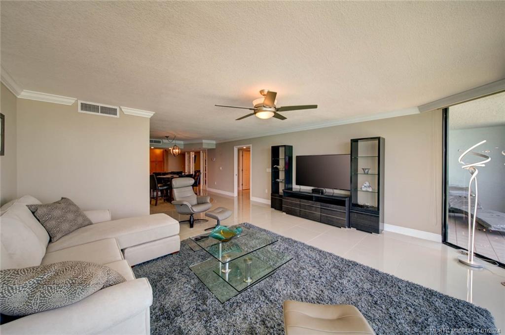 8800 South Ocean Drive, Unit 905 Jensen Beach, FL 34957 - Photo 21 of 67 a living room with furniture and a flat screen tv