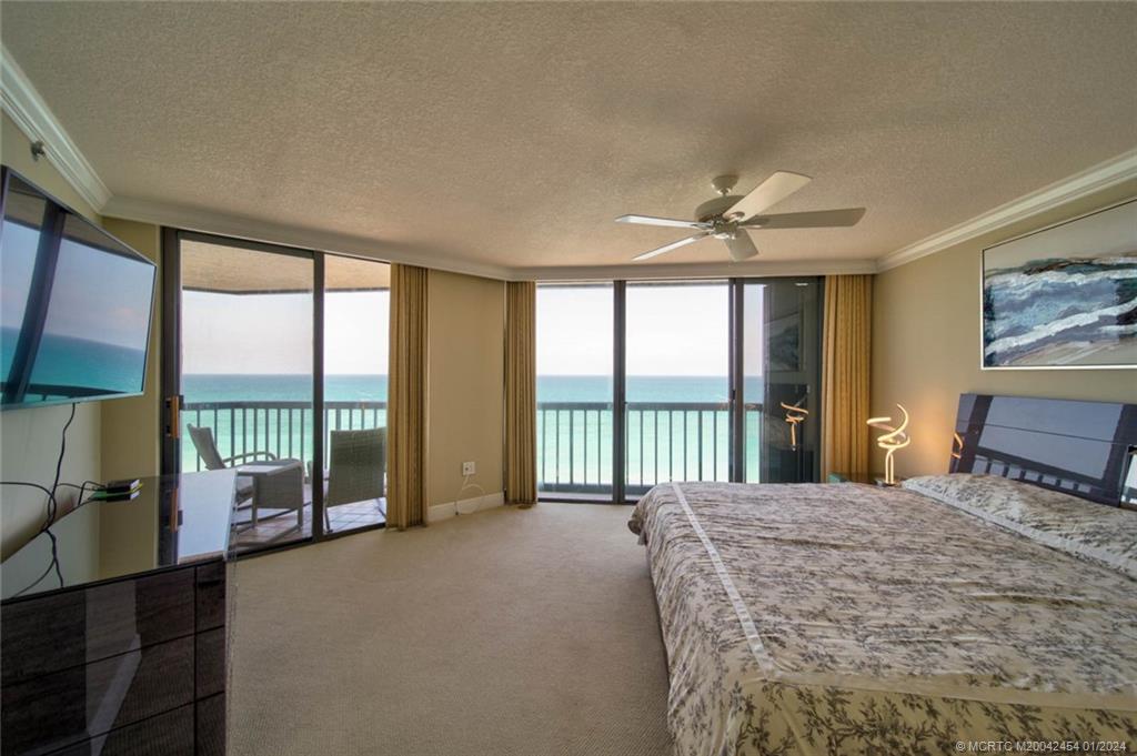 8800 South Ocean Drive, Unit 905 Jensen Beach, FL 34957 - Photo 23 of 67 a large bedroom with a large bed and a large window