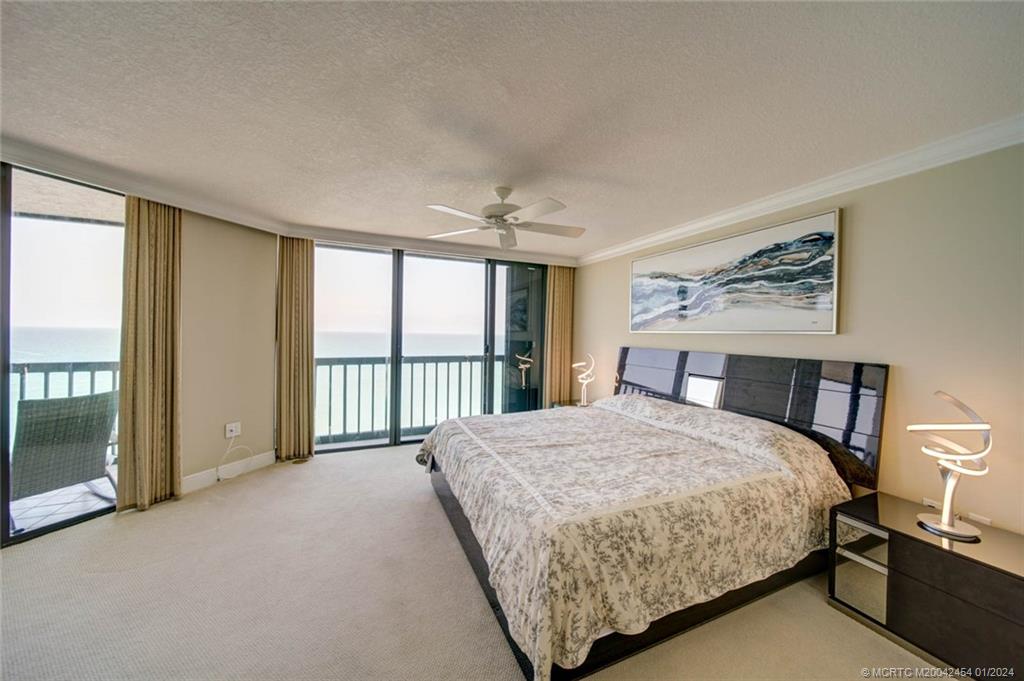 8800 South Ocean Drive, Unit 905 Jensen Beach, FL 34957 - Photo 24 of 67 a bedroom with a large bed and a large window