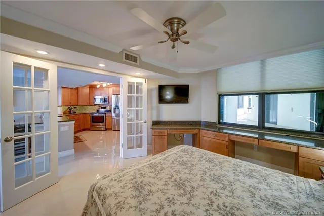 a view of a lake with a table and chairs in patio