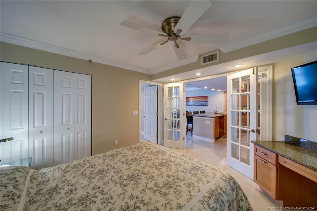 8800 South Ocean Drive, Unit 905 Jensen Beach, FL 34957 - Photo 38 of 67 a bedroom with a bed and a television