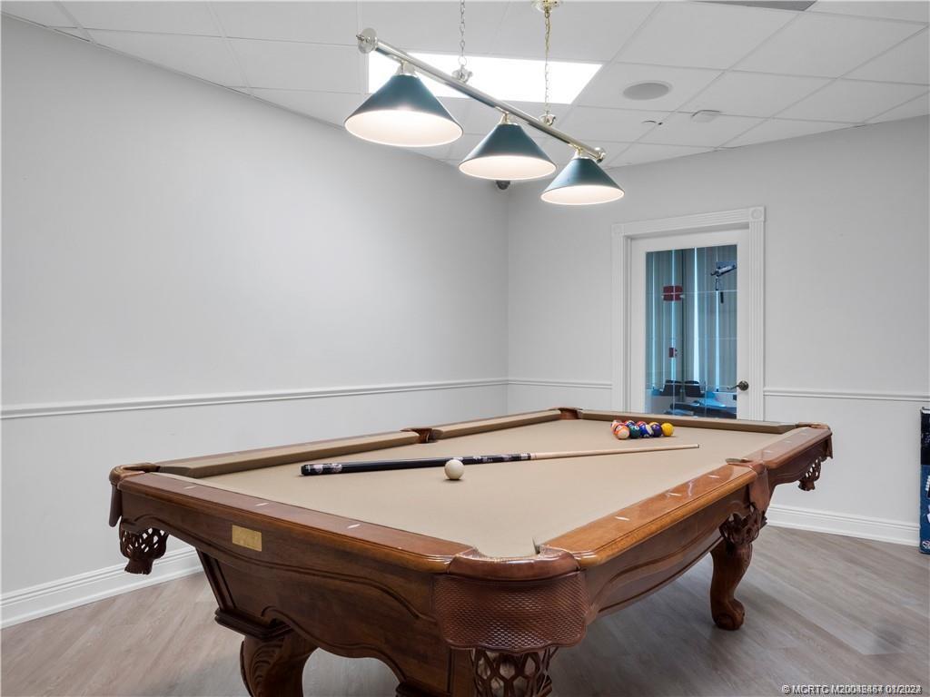 8800 South Ocean Drive, Unit 905 Jensen Beach, FL 34957 - Photo 66 of 67 a room with pool table and chandelier