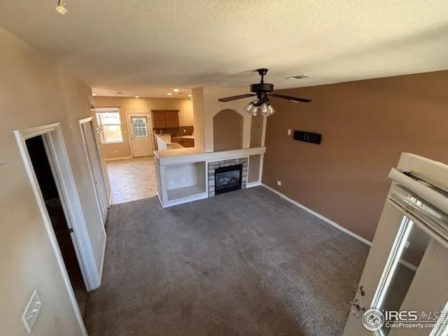 a view of a livingroom with furniture wooden floor and a window
