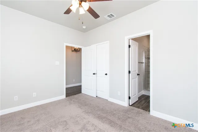 a view of a big room with a ceiling fan