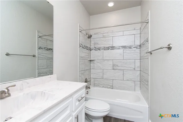 a bathroom with a bathtub toilet and sink