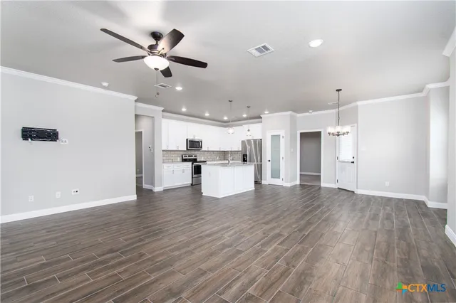 a view of kitchen with refrigerator microwave and wooden floor