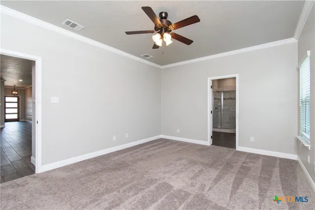 an empty room with fan and ceiling fan