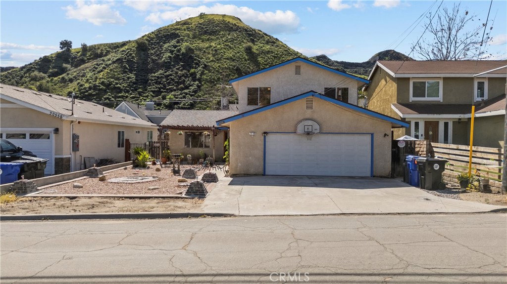 30602 San Martinez Road Val Verde, CA 91384 - Photo 1 of 1 a front view of a house with garden