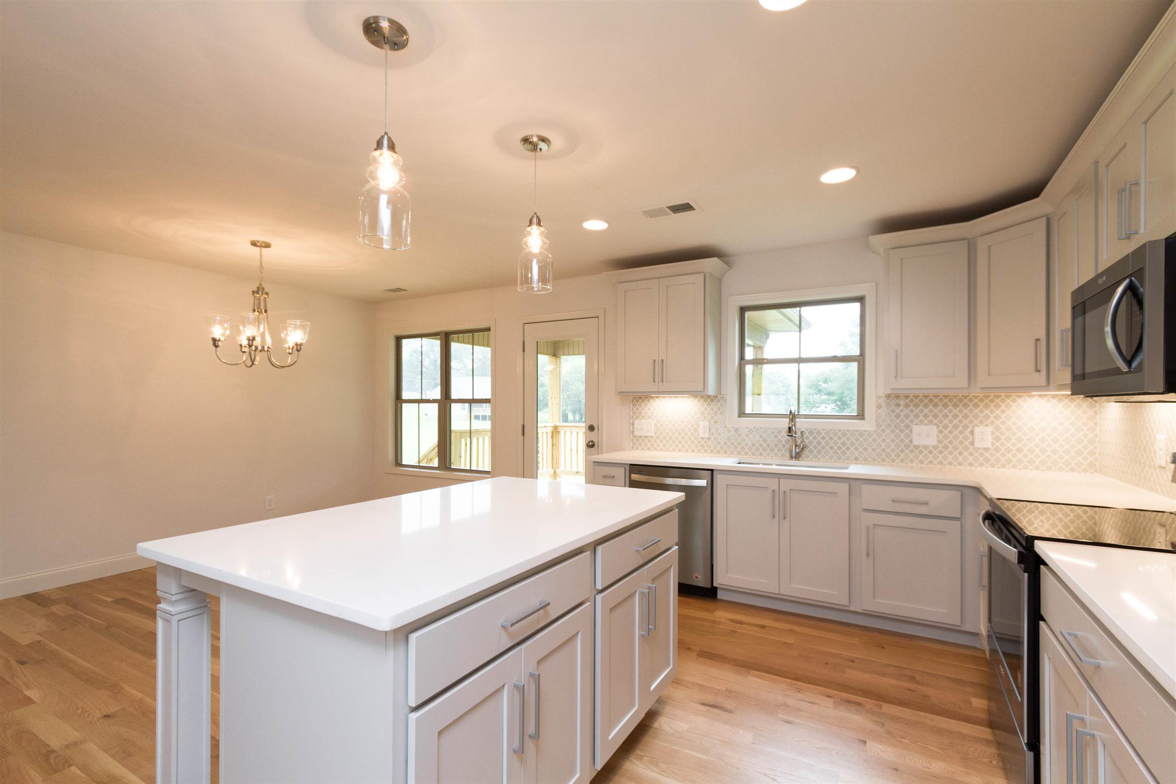 4121 Airport Road Springfield, TN 37172 - Photo 10 of 30 a large kitchen with kitchen island a sink a stove a center island and a window