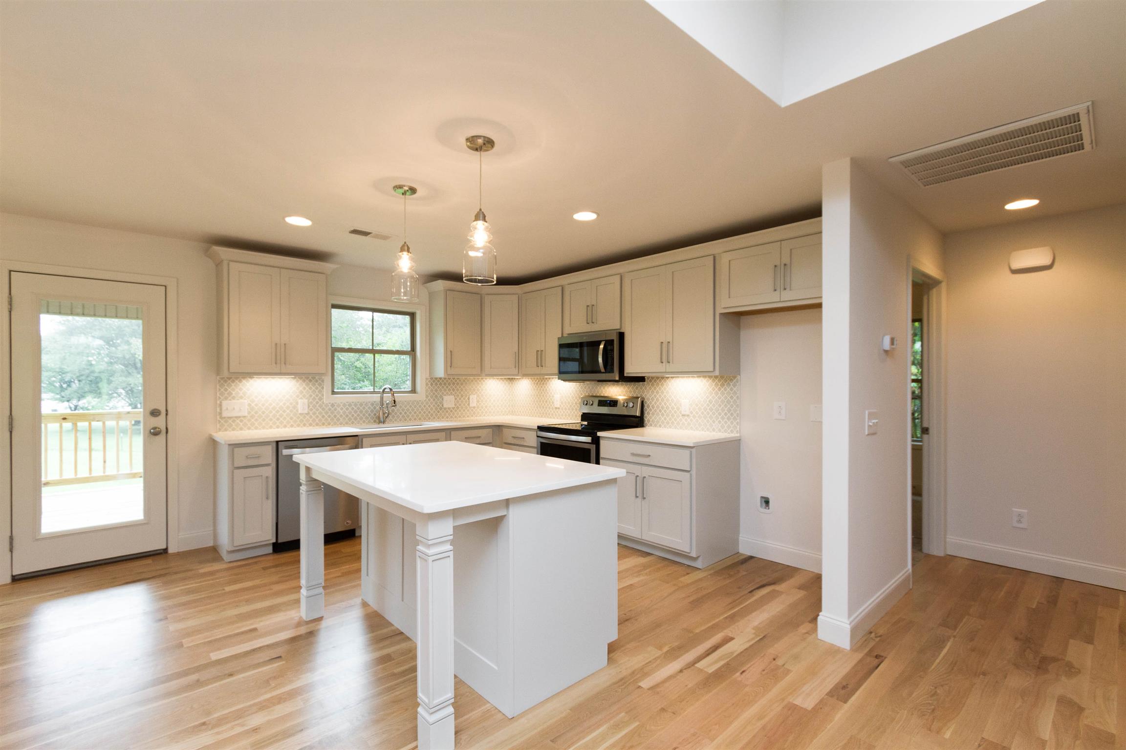 4121 Airport Road Springfield, TN 37172 - Photo 11 of 30 a kitchen with a sink a stove a refrigerator and white cabinets