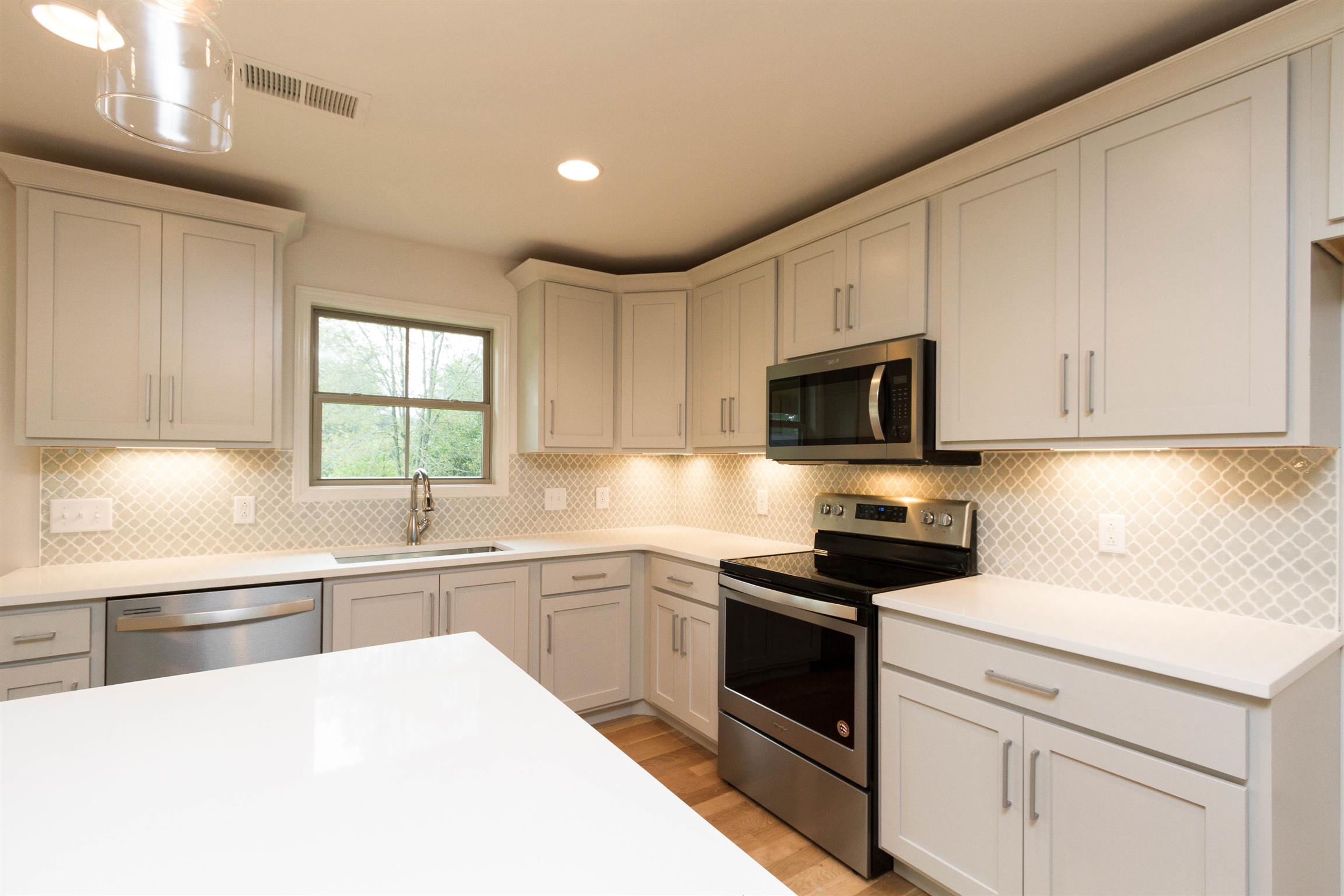 4121 Airport Road Springfield, TN 37172 - Photo 12 of 30 a kitchen with white cabinets stainless steel appliances and sink