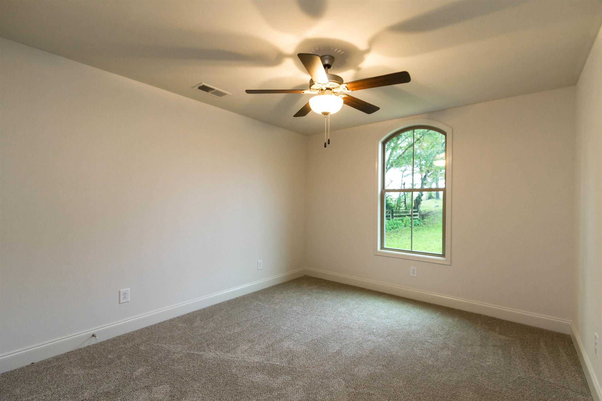 4121 Airport Road Springfield, TN 37172 - Photo 22 of 30 an empty room with a window and a fan