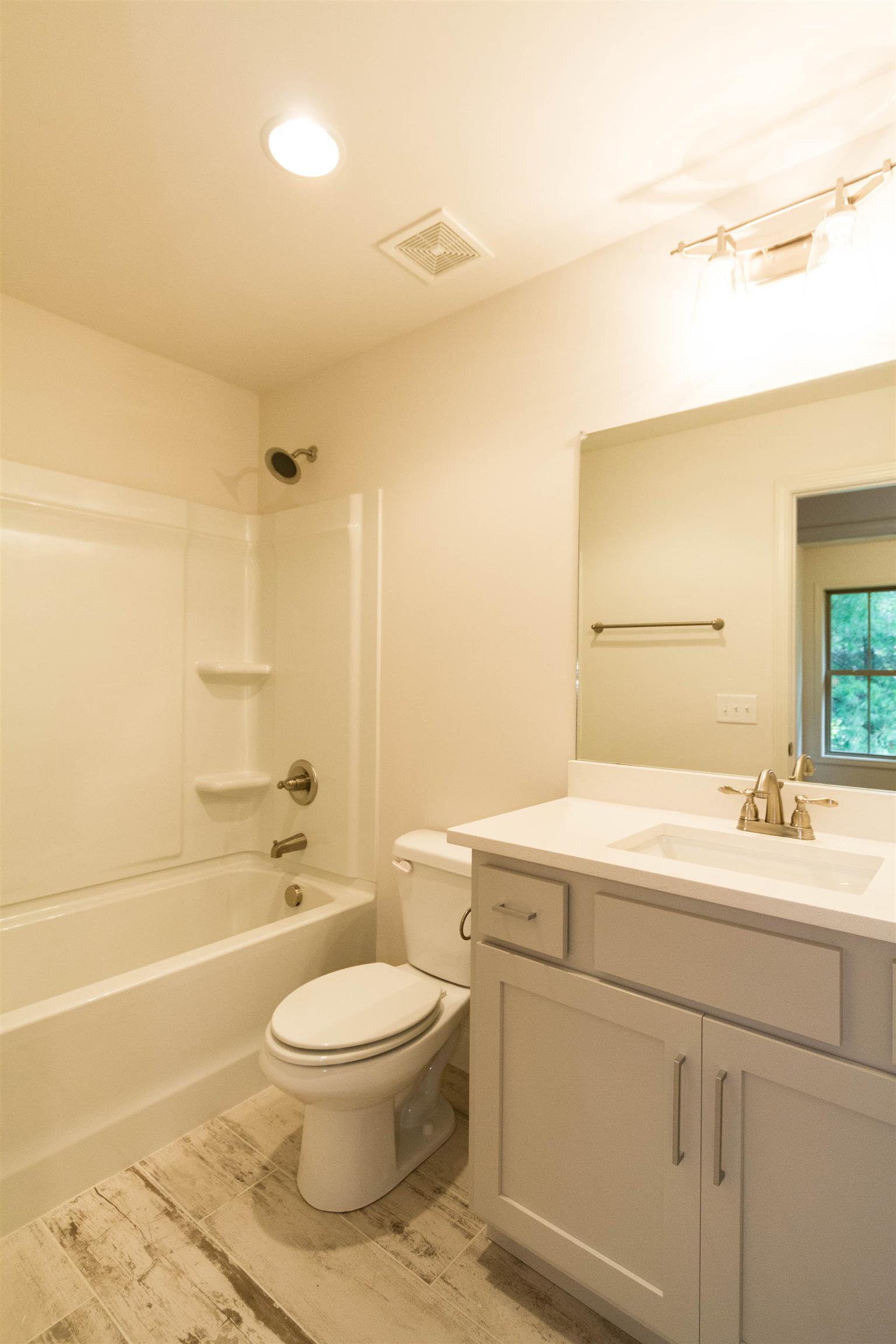 4121 Airport Road Springfield, TN 37172 - Photo 24 of 30 a bathroom with a toilet a sink a mirror and a bathtub