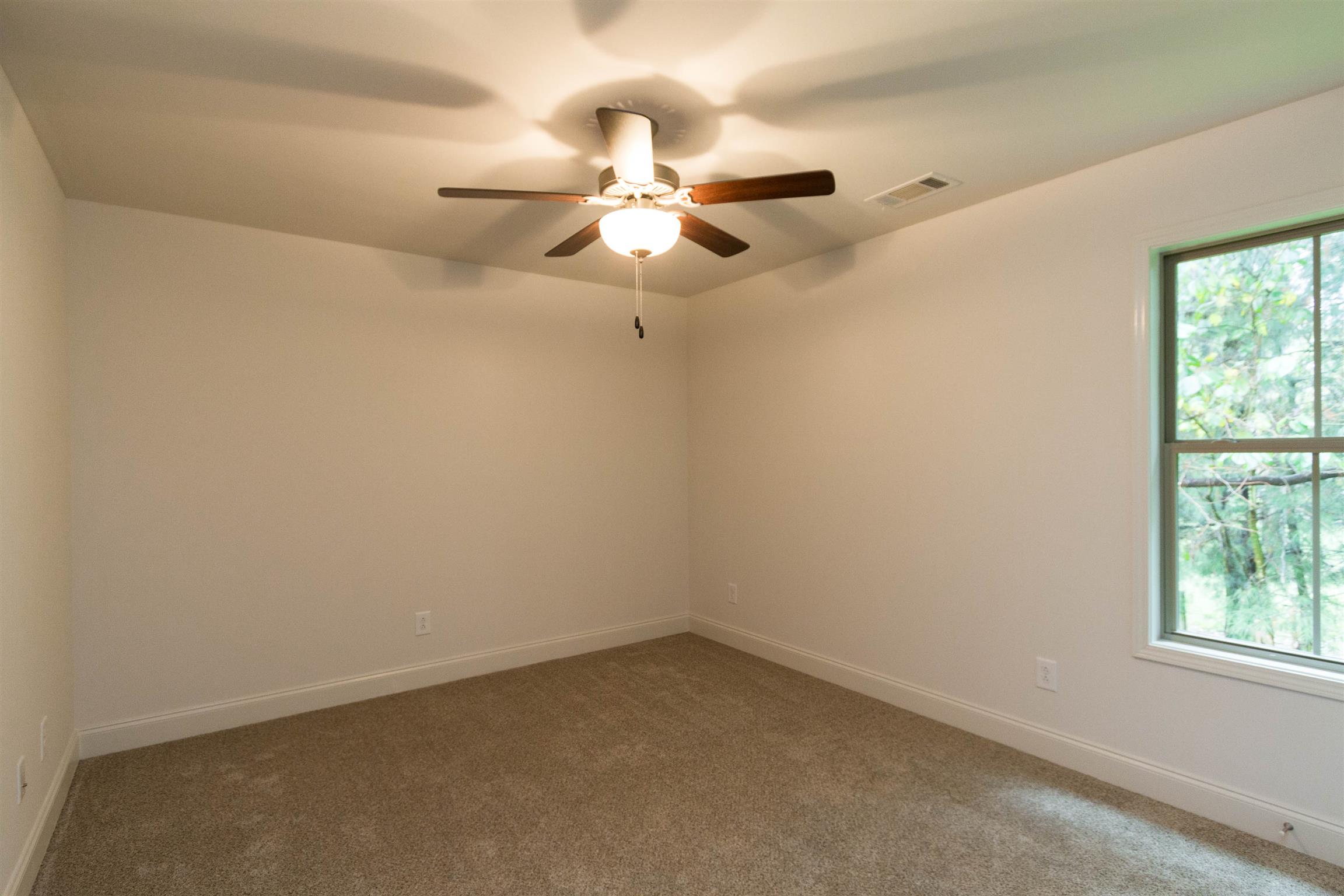 4121 Airport Road Springfield, TN 37172 - Photo 25 of 30 an empty room with a window and a fan