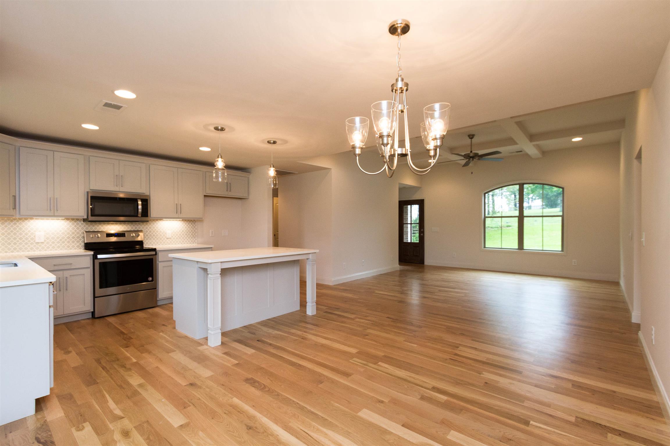 4121 Airport Road Springfield, TN 37172 - Photo 7 of 30 a large kitchen with granite countertop a large kitchen island a sink dishwasher a refrigerator and a fireplace
