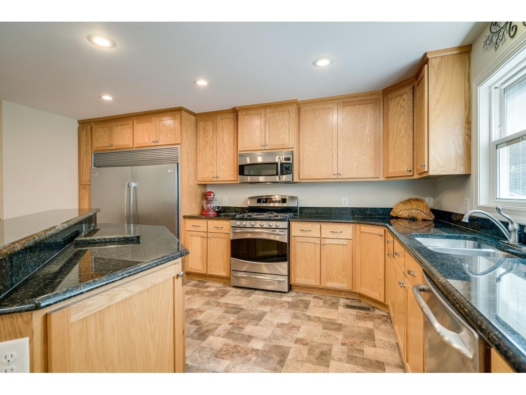 5946 Hurdle Mills Road Roxboro, NC 27574 - Photo 8 of 23 a kitchen with granite countertop a sink stove and refrigerator