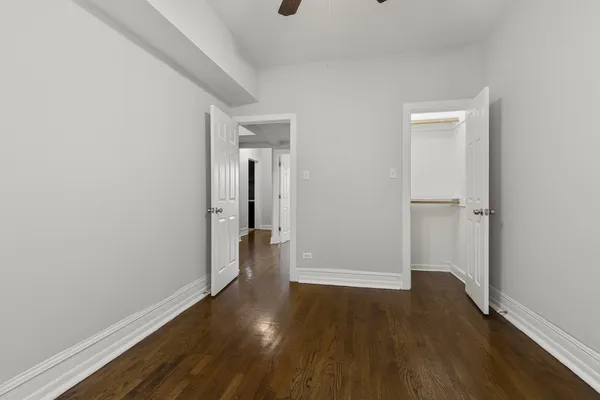 a view of a room with wooden floor and a window