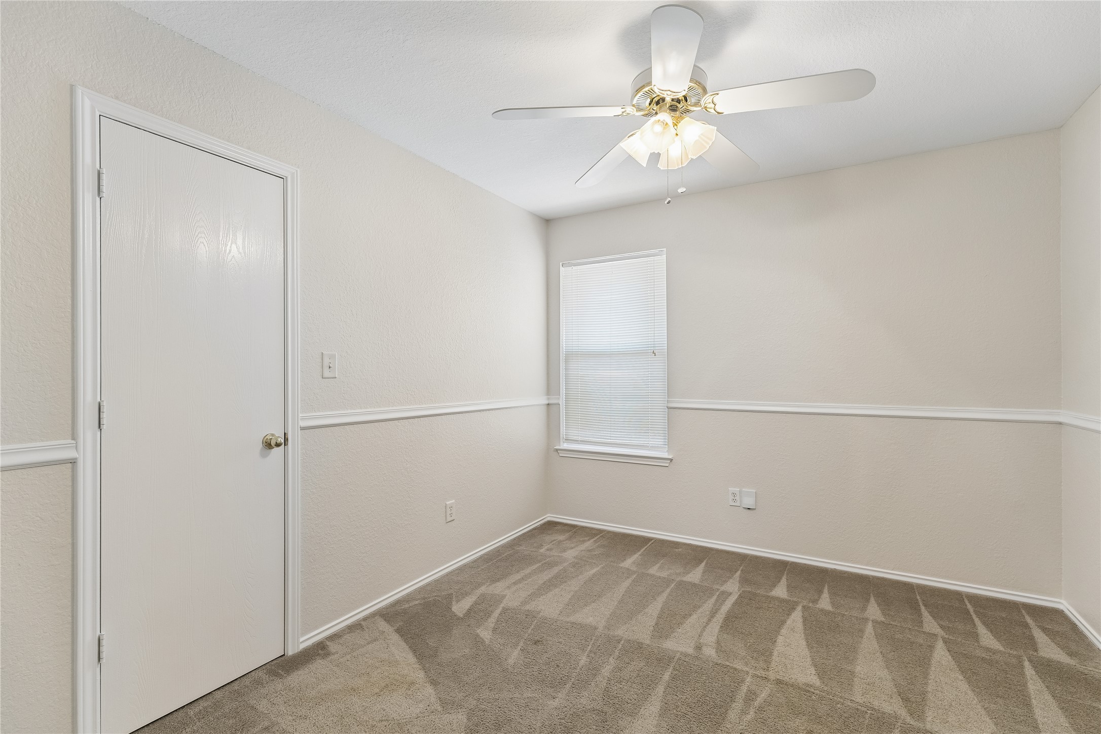 104 Cavalry Trail Elgin, TX 78621 - Photo 15 of 26 Bedroom 2 also has a ceiling fan.