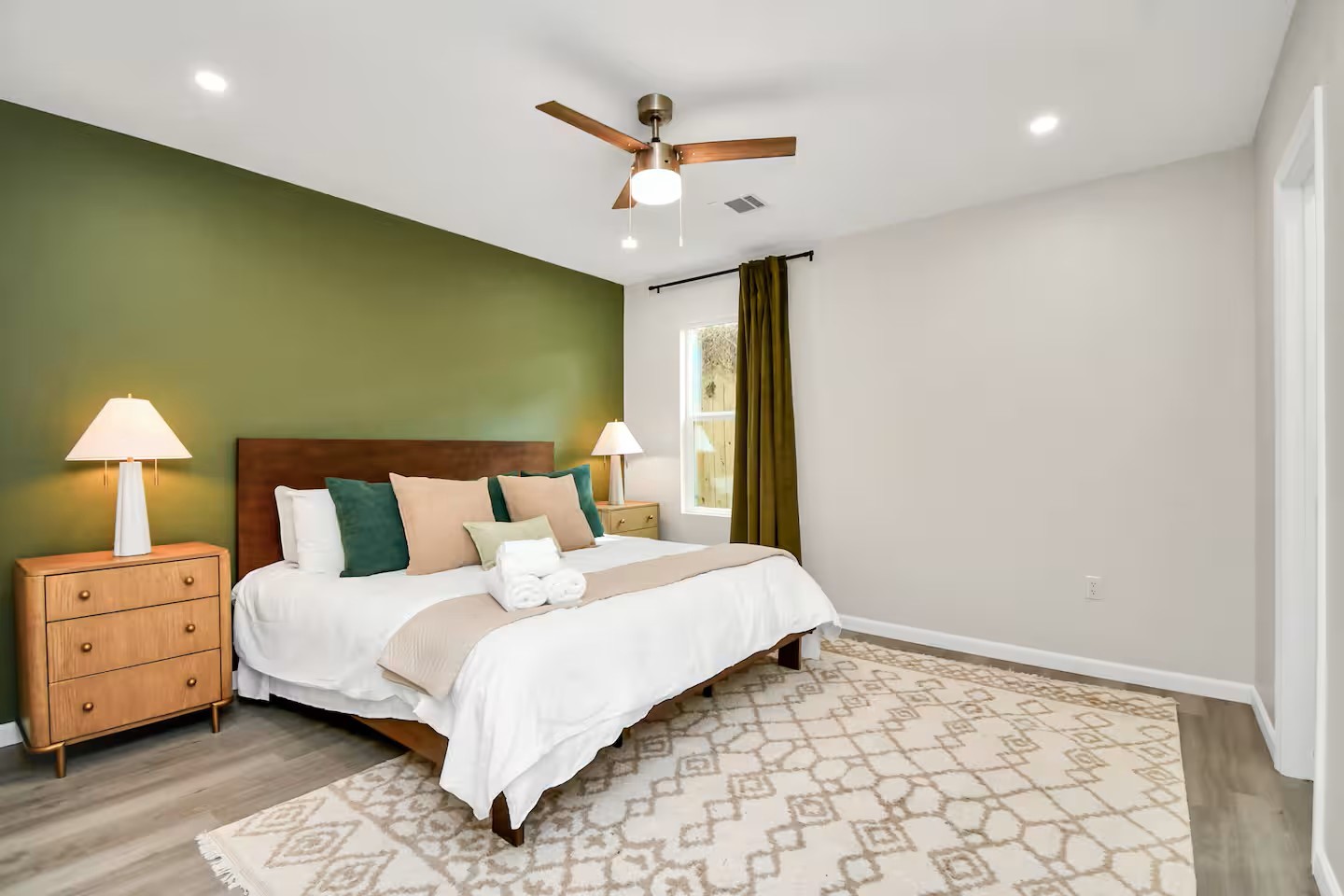 3318 Wichita Street Houston, TX 77004 - Photo 22 of 36 a bedroom with a bed and a ceiling fan