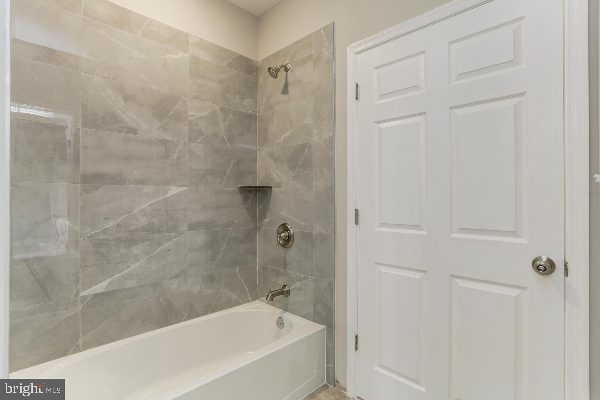 1923 Ashland Avenue, Unit 303 Baltimore, MD 21205 - Photo 11 of 13 a bathroom with a bathtub