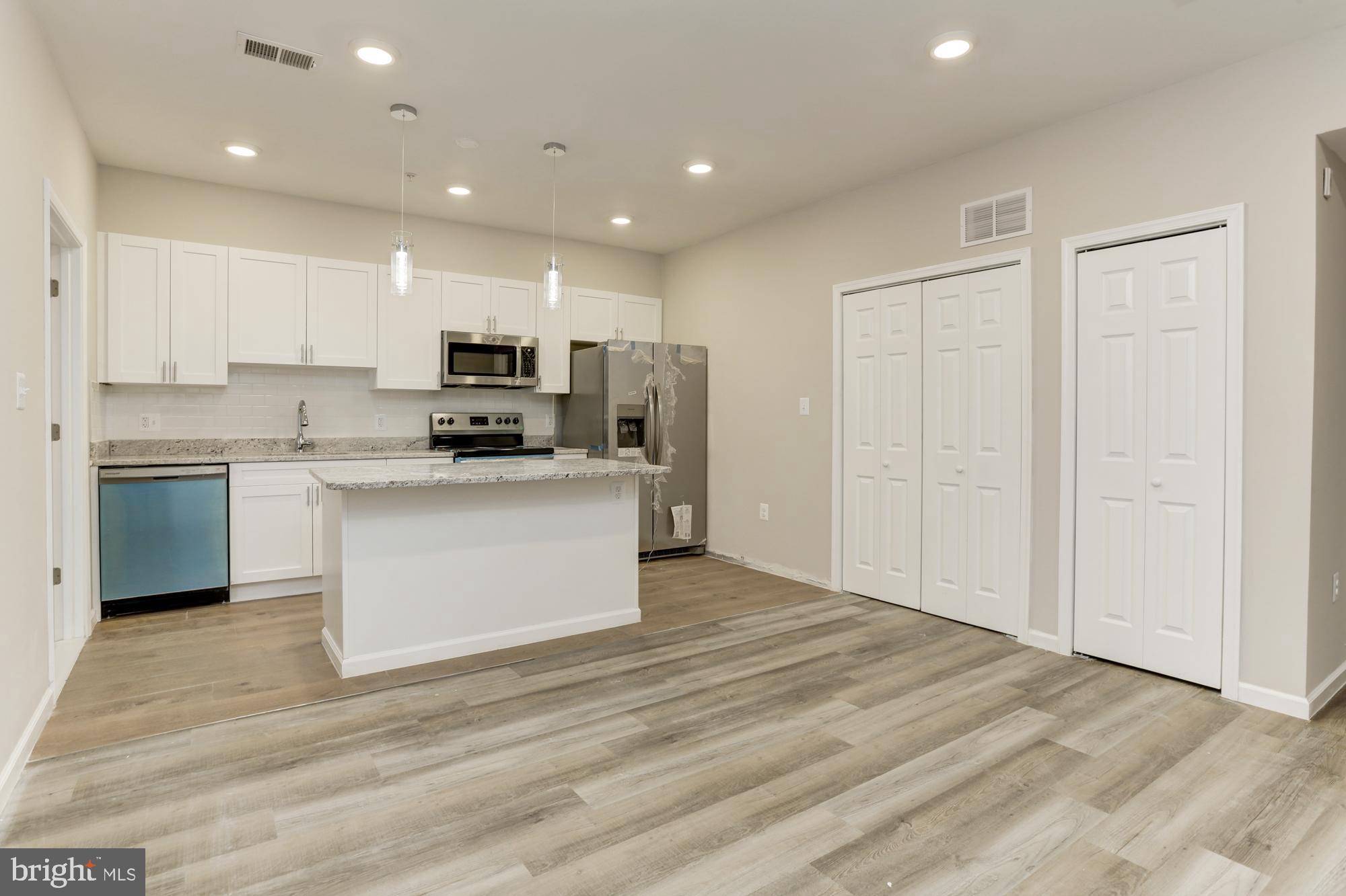 1923 Ashland Avenue, Unit 303 Baltimore, MD 21205 - Photo 3 of 13 a view of kitchen with wooden floor and electronic appliances