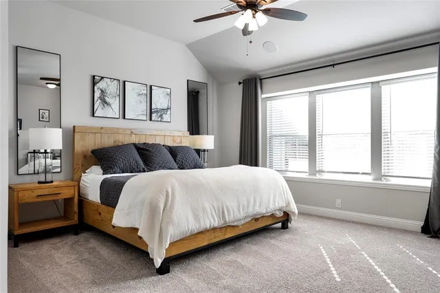 a spacious bedroom with a bed and window