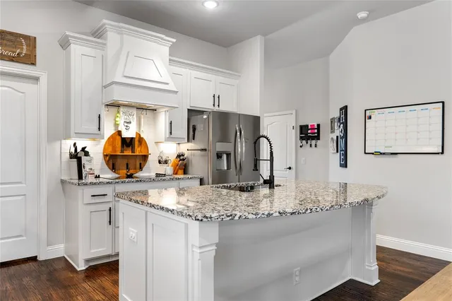 a kitchen with stainless steel appliances granite countertop a sink and cabinets
