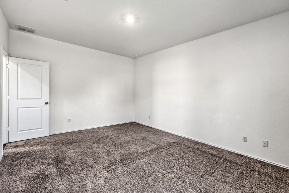 385 Geode Glen Maxwell, TX 78656 - Photo 11 of 16 Primary bedroom featuring carpet