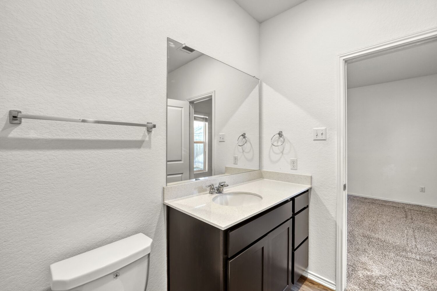 385 Geode Glen Maxwell, TX 78656 - Photo 13 of 16 Primary bathroom featuring a textured wall, and vanity
