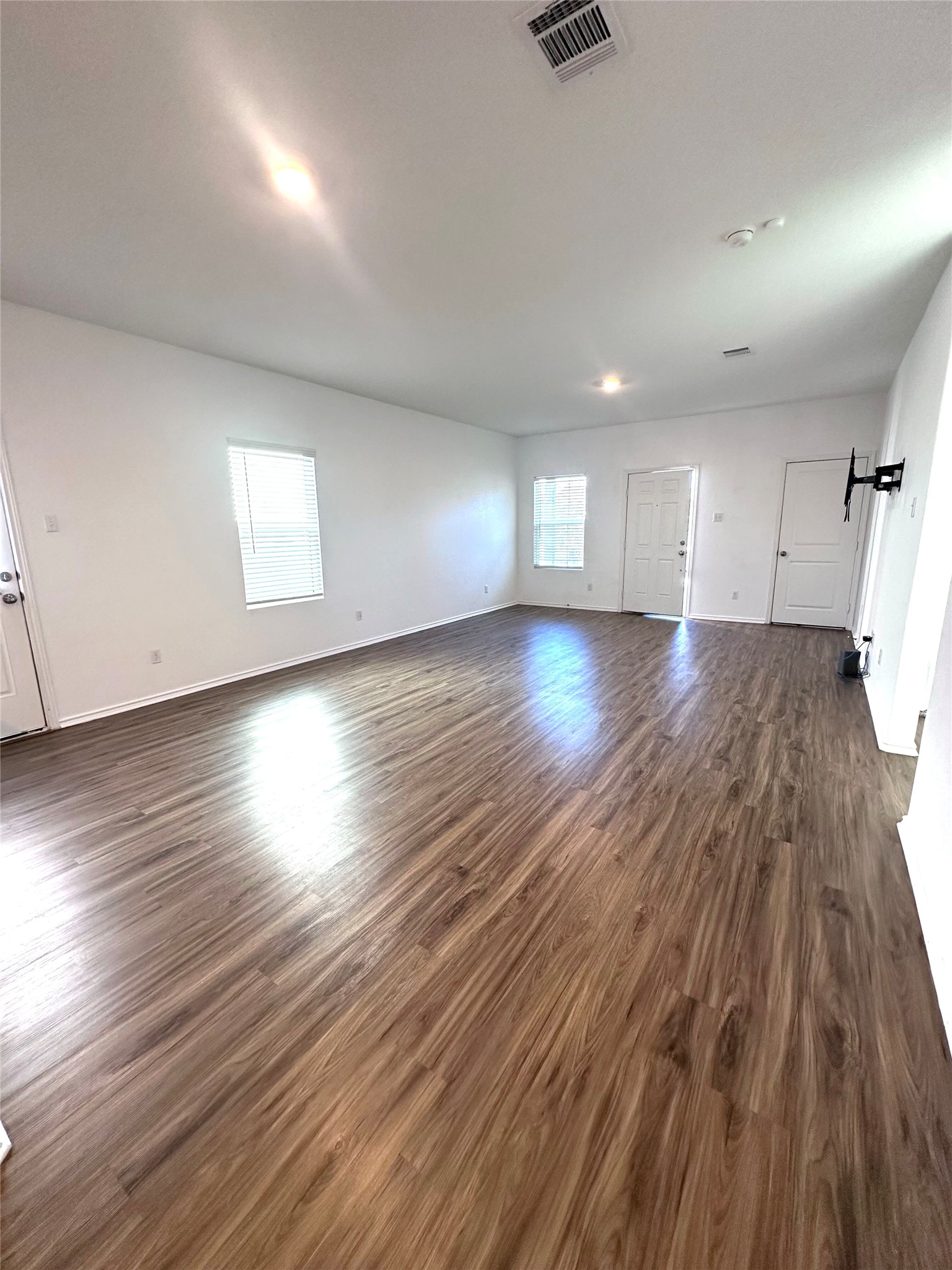 385 Geode Glen Maxwell, TX 78656 - Photo 5 of 16 Unfurnished living room featuring wood finished floors and baseboards