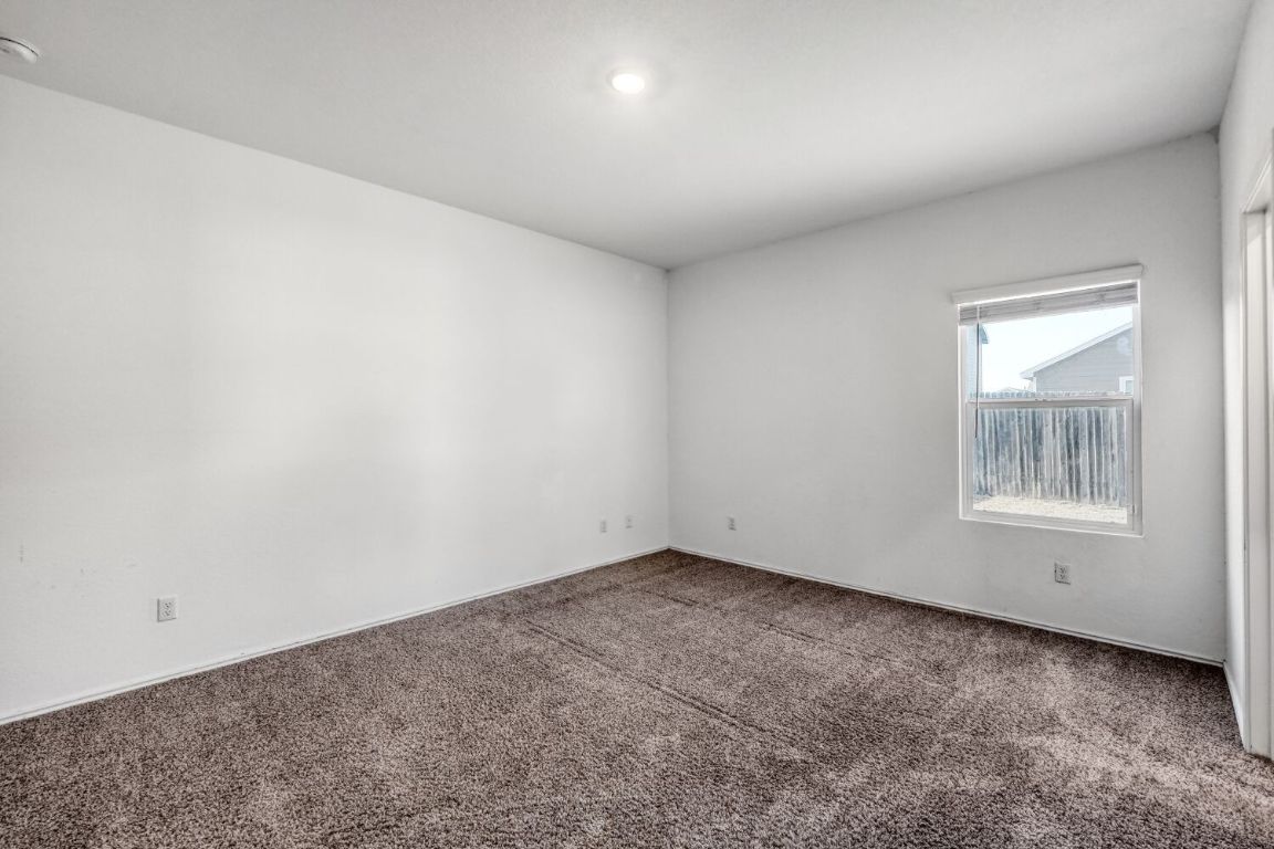385 Geode Glen Maxwell, TX 78656 - Photo 10 of 16 Primary bedroom with carpet floor