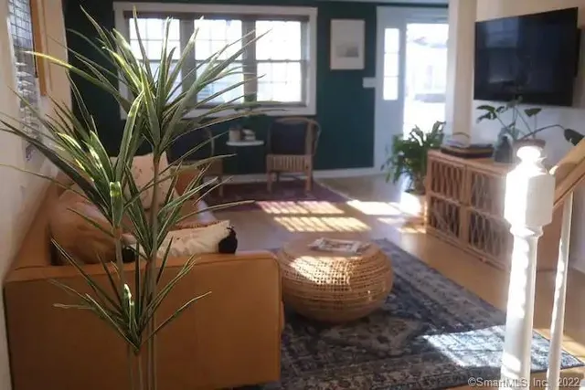 a view of living room filled with furniture and a flat screen tv