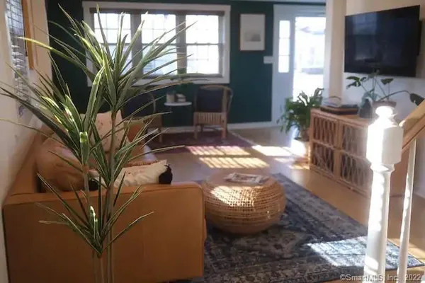 a view of living room filled with furniture and a flat screen tv