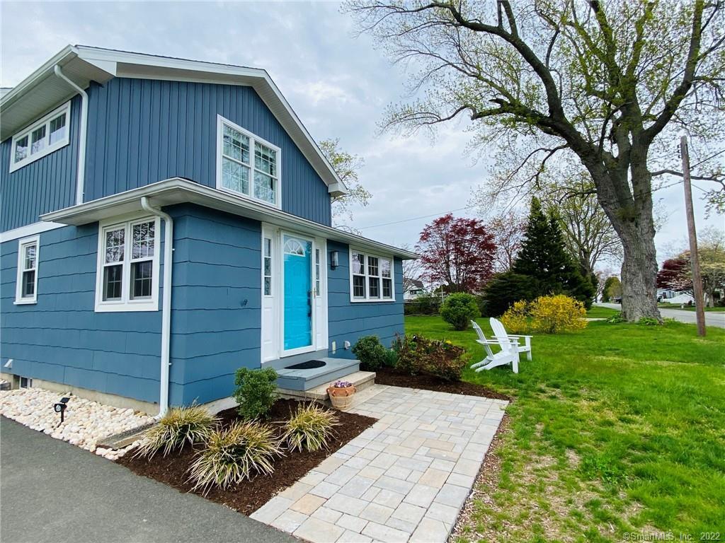 8 Clinton Avenue Old Saybrook, CT 06475 - Photo 15 of 23 a front view of a house with garden