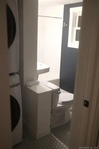 a living room with chairs and a potted plant