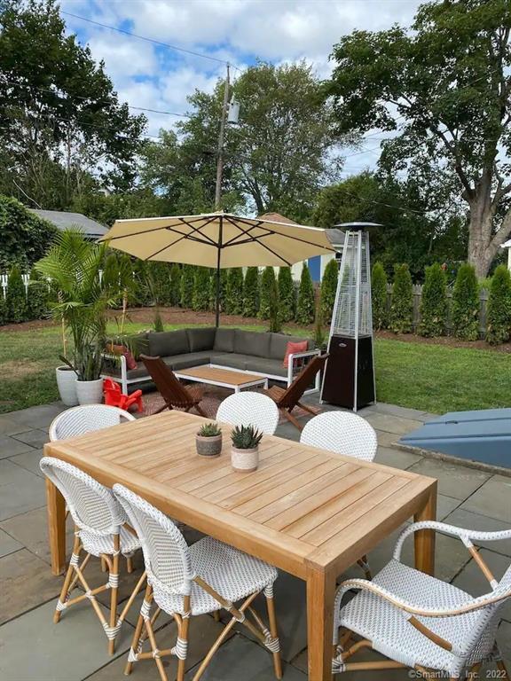 8 Clinton Avenue Old Saybrook, CT 06475 - Photo 2 of 23 a patio with a table and chairs