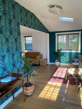 a bed room with a bed and a potted plant