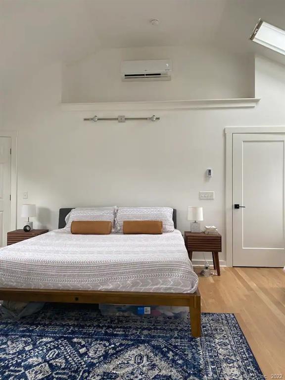 8 Clinton Avenue Old Saybrook, CT 06475 - Photo 6 of 23 a bedroom with a bed and a table in it