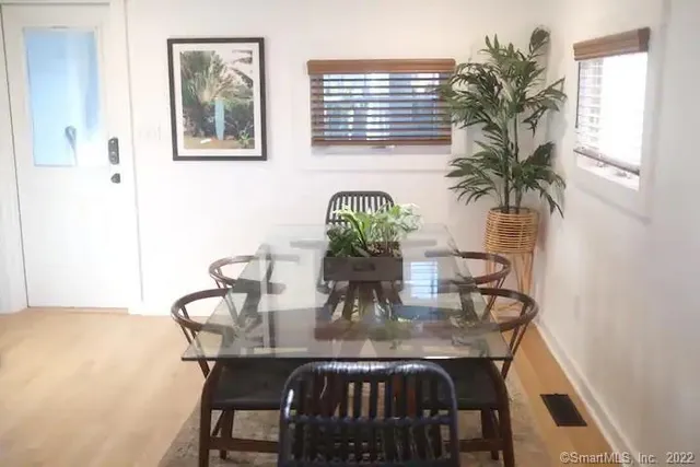 a dining room with furniture and window