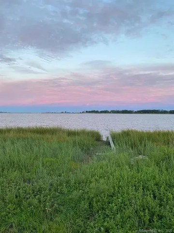 a view of a lake and sunset