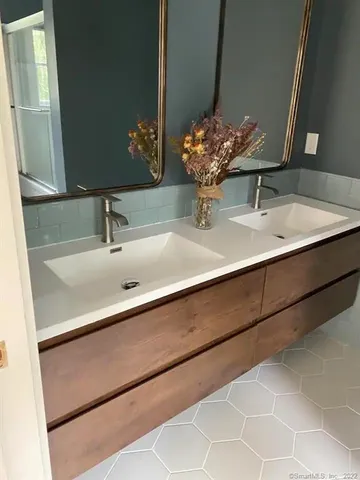 a bathroom with a sink and a mirror