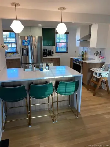 a view of a a dining room with furniture window and wooden floor