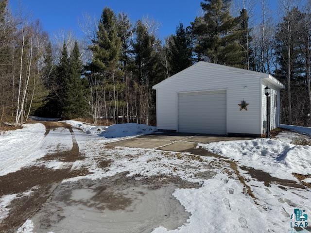 15081 Old Hart Lake Road Goodland, MN 55742 - Photo 13 of 18 Snow covered garage featuring a garage